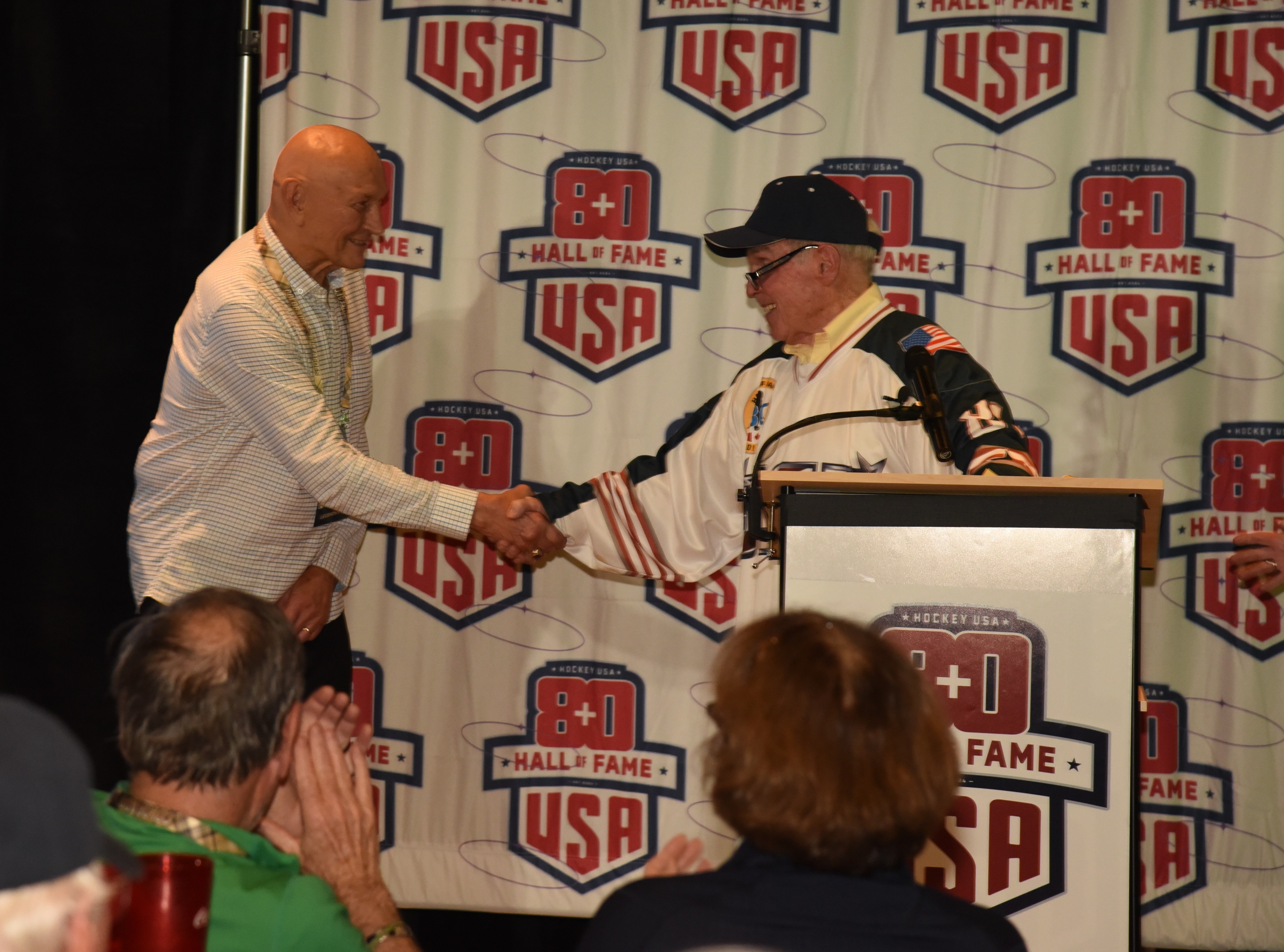 Bill Orban during an induction weekend handshake moment