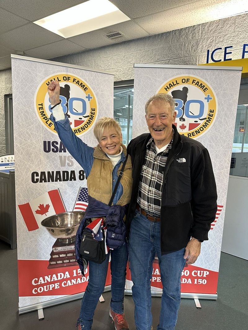 Bob and Dorothy Priestley celebrating in front of the Canada 150 Cup banner, 2023