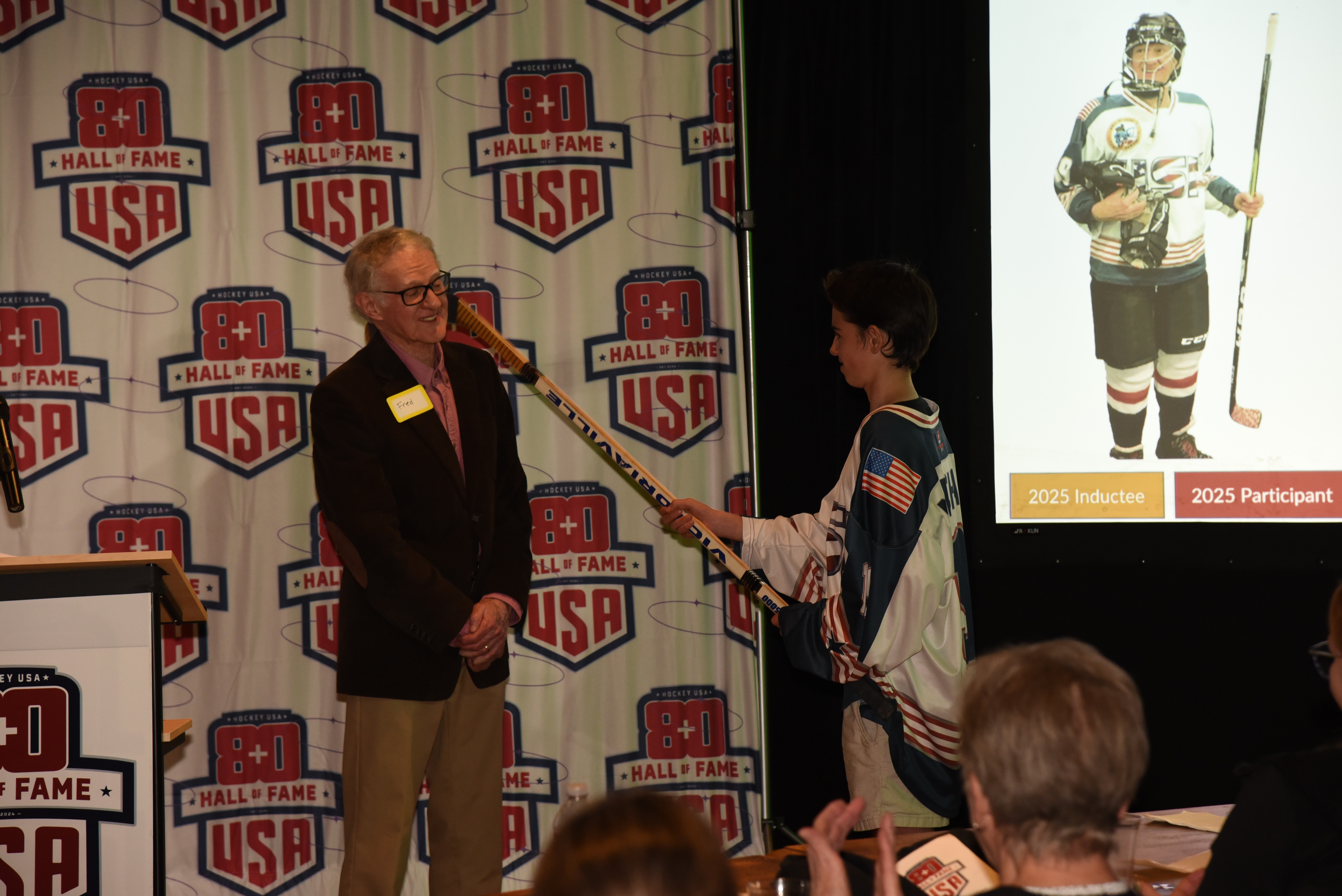 Fred Merchant with his grandson during the 2025 USA 80+ Hockey Hall of Fame induction weekend