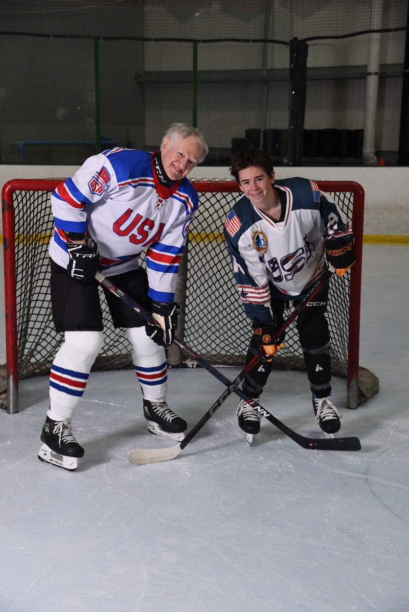Fred Merchant and grandson Jack on the ice together in USA jerseys
