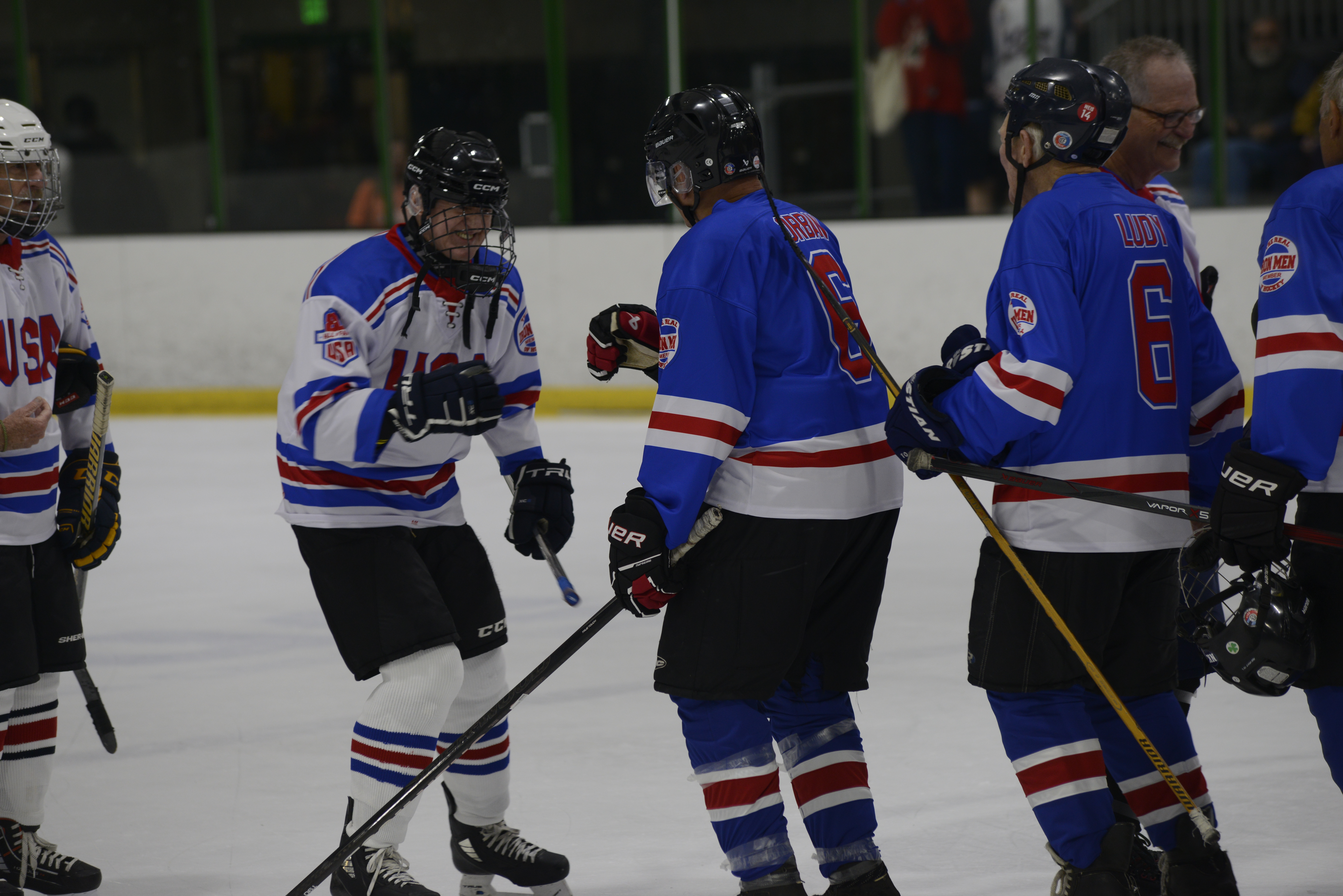 Fred Merchant and Bill Orban shaking hands during the Legends Game weekend