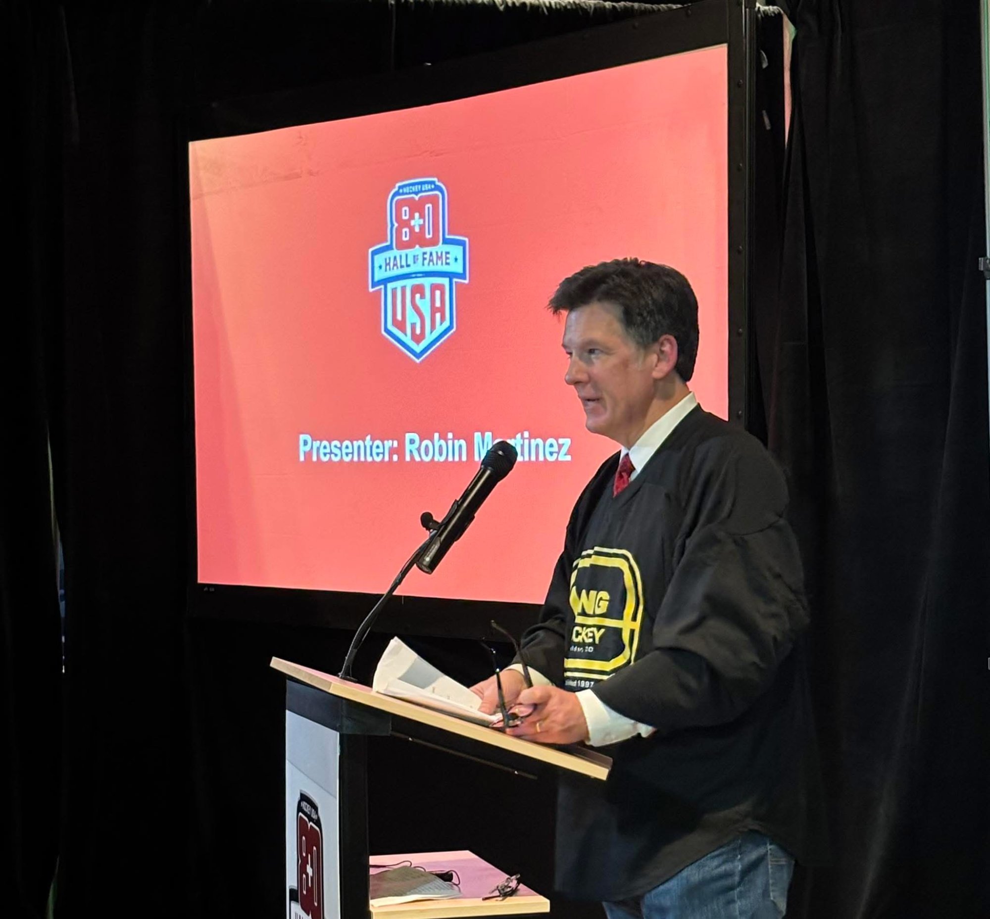 Sean Moynihan presenting at the 2025 USA 80+ Hockey Hall of Fame Induction Ceremony